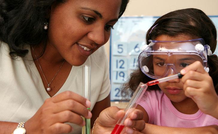 Woman and young girl with test tubes